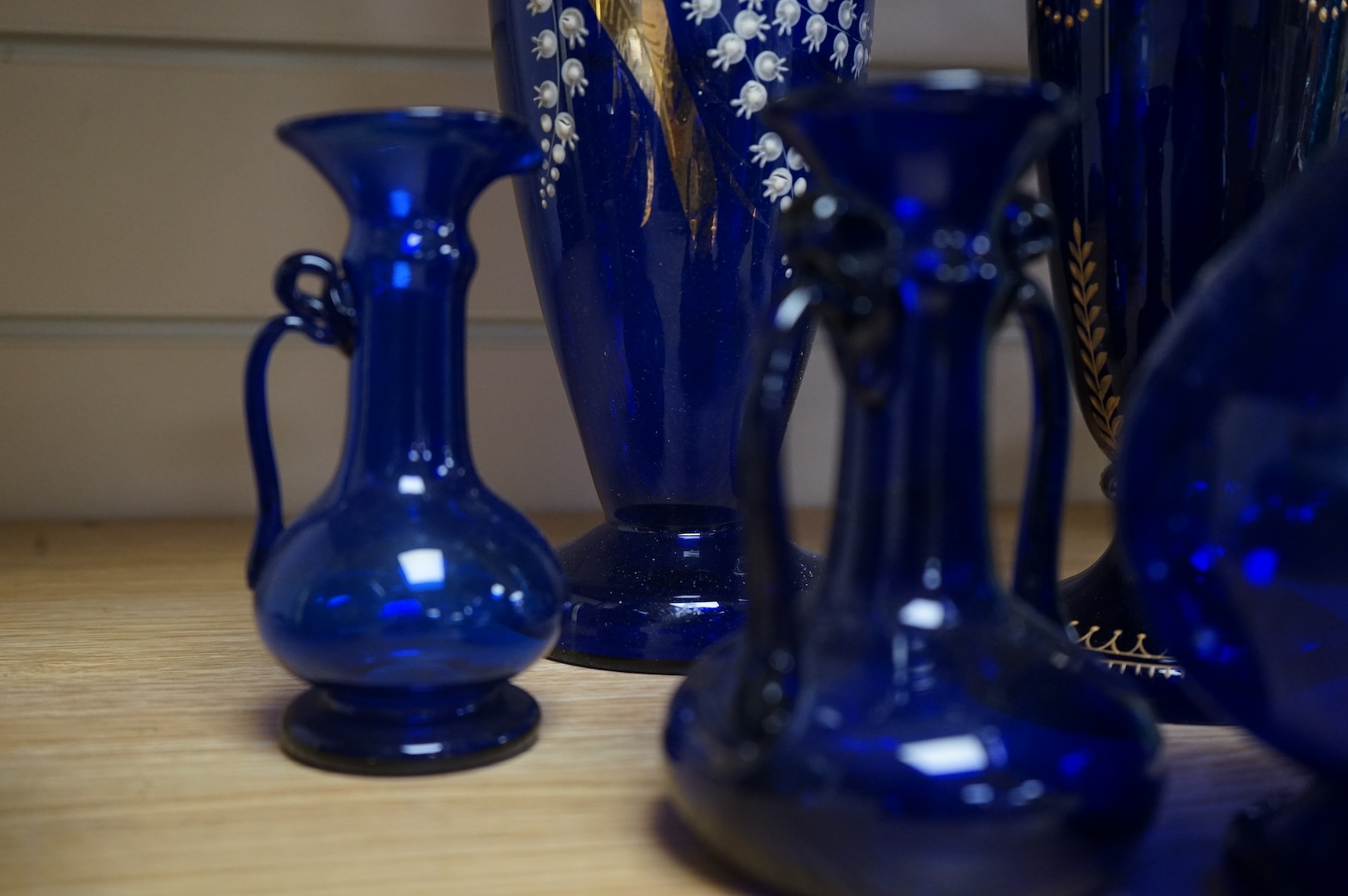 A collection of Bristol blue glassware to include enamel and gilt decanters, together with other glassware, baskets etc, largest 33cm high